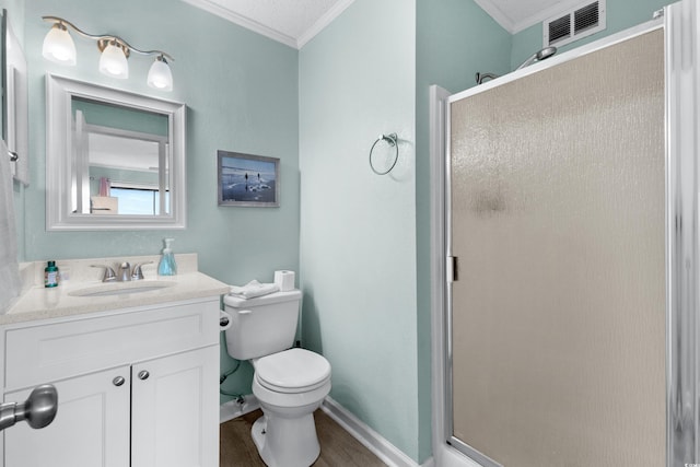 bathroom featuring vanity, walk in shower, hardwood / wood-style floors, ornamental molding, and toilet