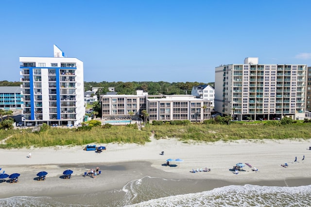 view of property with a water view and a view of the beach