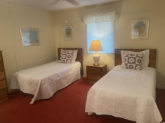 bedroom featuring dark carpet and ceiling fan