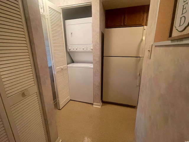 laundry area with stacked washing maching and dryer