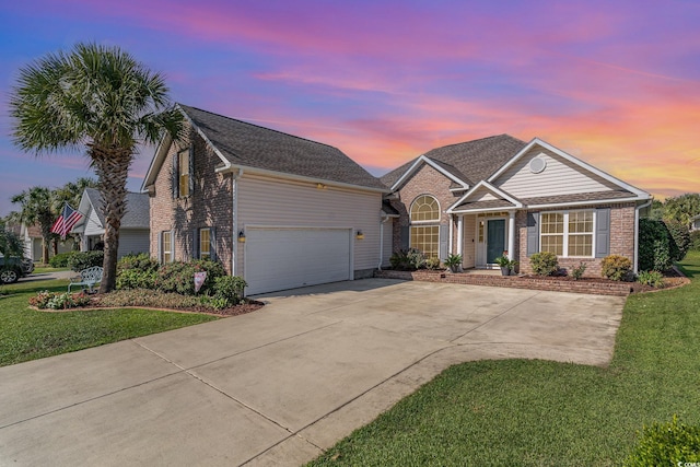 view of front of home featuring a garage and a yard