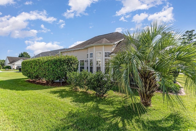 view of home's exterior with a yard