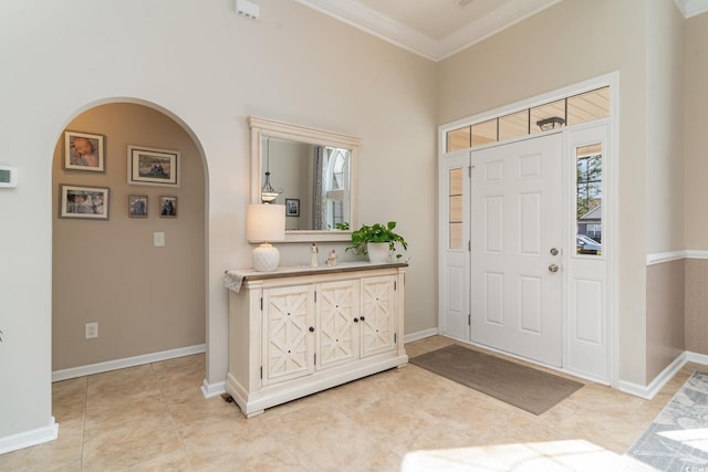 tiled entrance foyer featuring ornamental molding