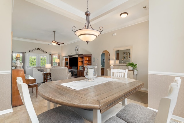 dining space featuring crown molding, ceiling fan, a tray ceiling, and light tile patterned floors