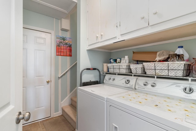 washroom with cabinets and washing machine and dryer