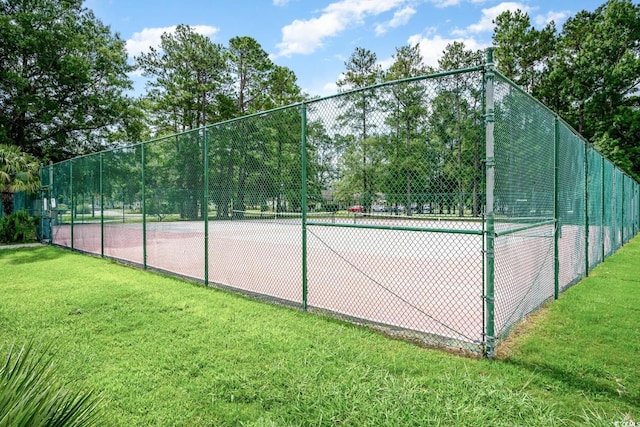 view of sport court featuring a lawn