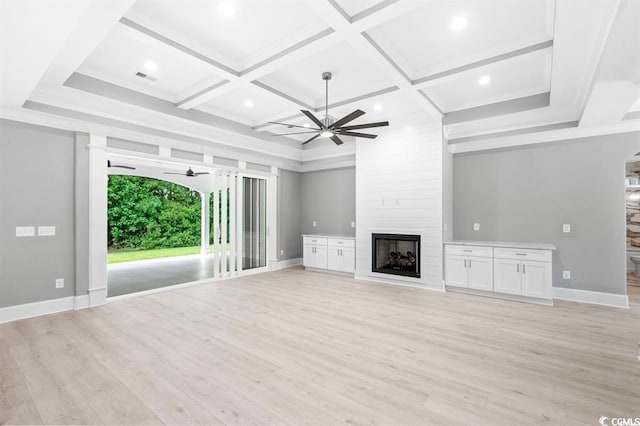 unfurnished living room featuring coffered ceiling, ceiling fan, a large fireplace, and light hardwood / wood-style floors