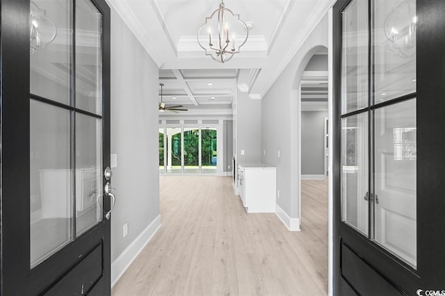 entrance foyer with ceiling fan with notable chandelier, beamed ceiling, coffered ceiling, and light hardwood / wood-style floors