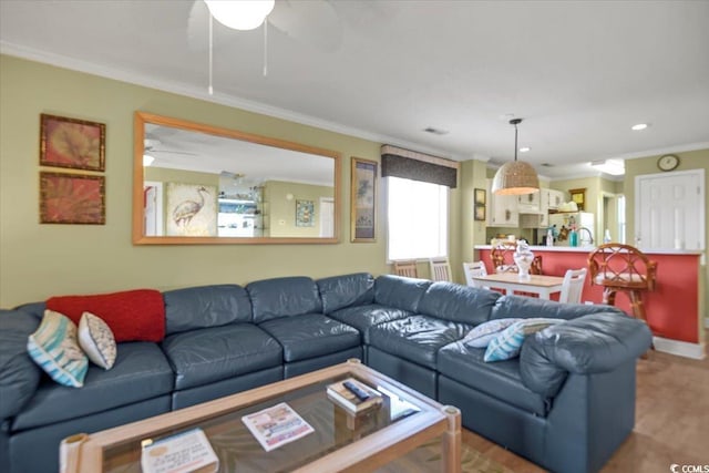 living area with recessed lighting, ceiling fan, and ornamental molding