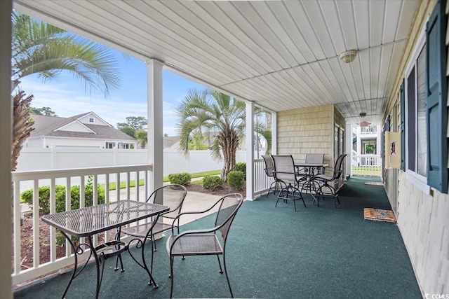 view of patio with outdoor dining space and fence