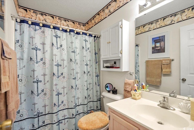 bathroom with a shower with shower curtain, a textured ceiling, vanity, and toilet