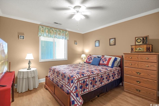 bedroom with visible vents, crown molding, and light wood-style floors