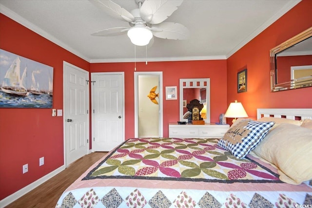 bedroom with crown molding, wood finished floors, baseboards, and ceiling fan