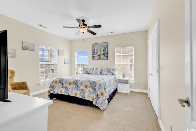 bedroom with light carpet, visible vents, and baseboards