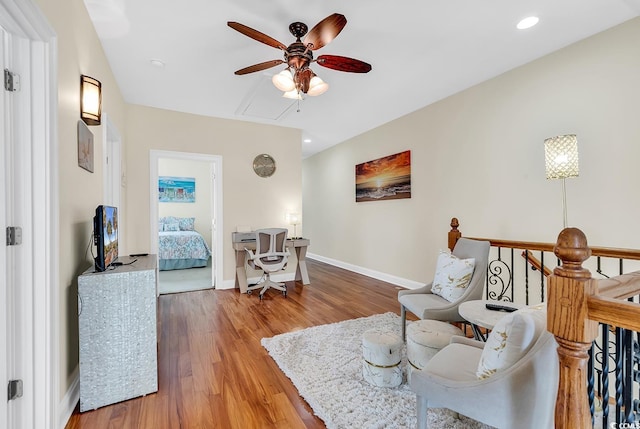 interior space with ceiling fan, recessed lighting, wood finished floors, an upstairs landing, and baseboards