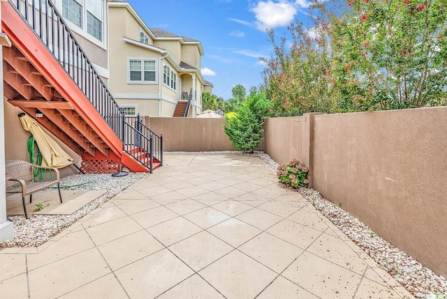 view of patio / terrace featuring stairway and a fenced backyard