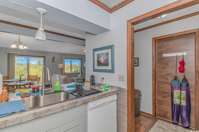 kitchen featuring pendant lighting, a notable chandelier, light hardwood / wood-style flooring, white dishwasher, and white cabinets