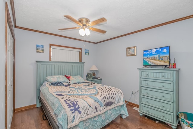 bedroom with ornamental molding, a closet, ceiling fan, and dark hardwood / wood-style floors