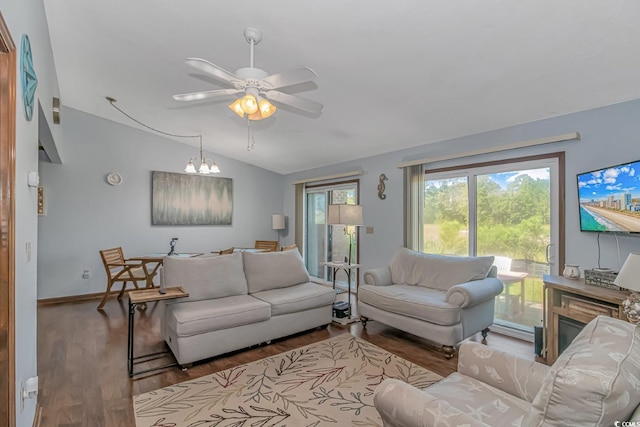 living room featuring vaulted ceiling, ceiling fan, and dark hardwood / wood-style floors