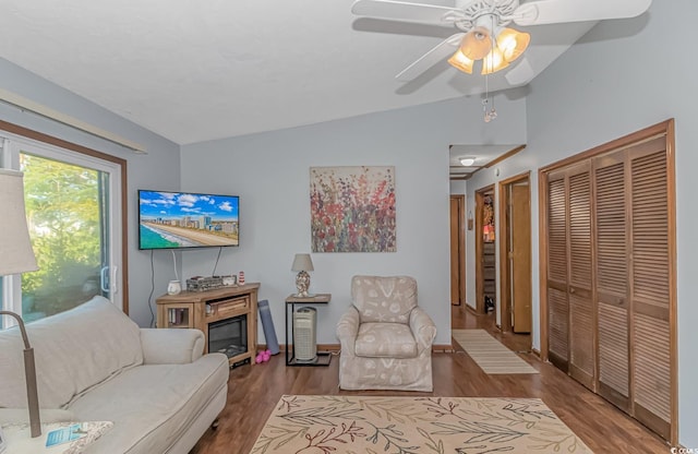 living room with vaulted ceiling, hardwood / wood-style floors, and ceiling fan