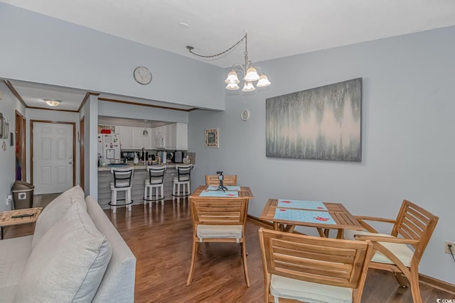 dining area featuring hardwood / wood-style flooring and a notable chandelier