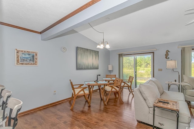 dining space featuring lofted ceiling, an inviting chandelier, and hardwood / wood-style floors