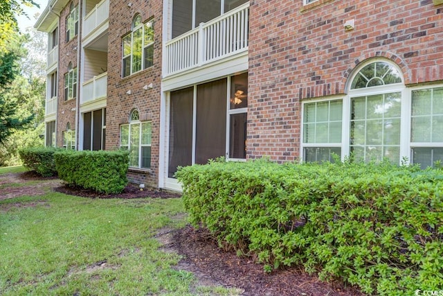 view of exterior entry with a lawn