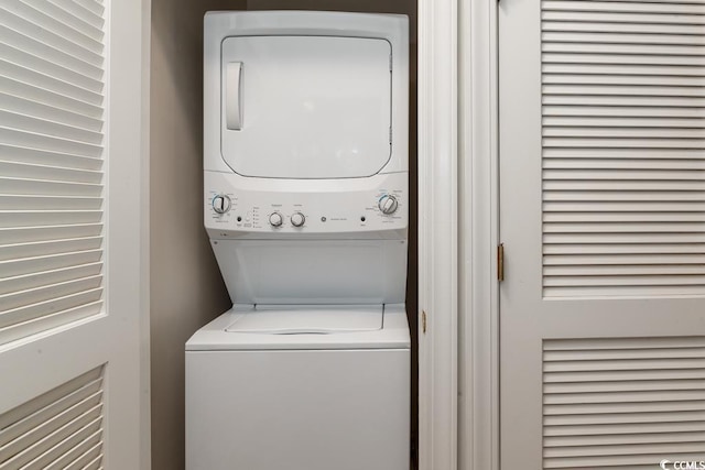 laundry area with stacked washer and clothes dryer