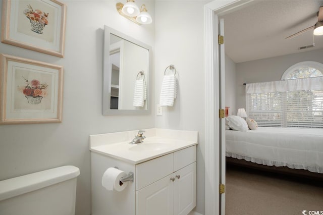 bathroom with vanity, ceiling fan, and toilet