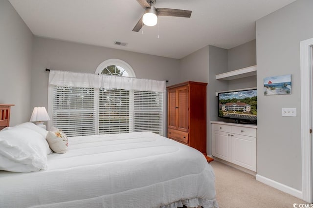 bedroom featuring ceiling fan and light carpet