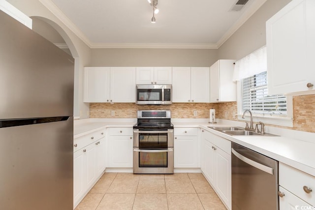 kitchen with sink, stainless steel appliances, white cabinets, and light tile patterned flooring