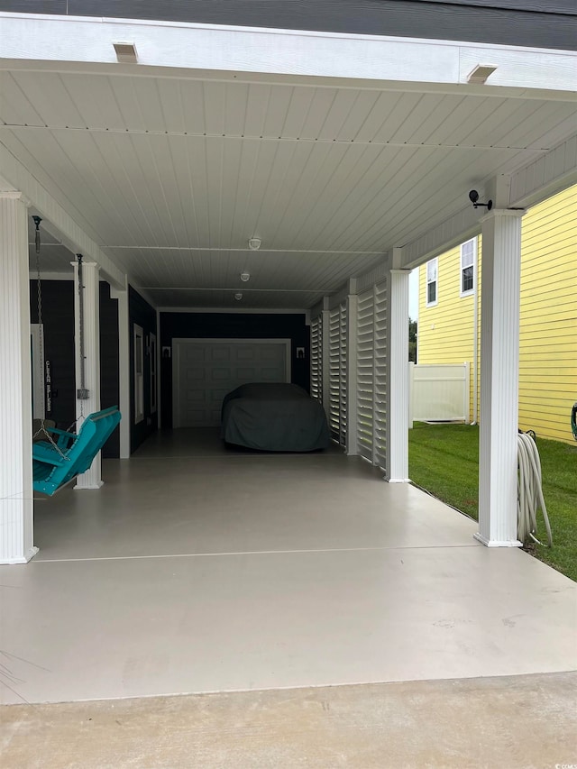 view of patio / terrace featuring a garage and a carport