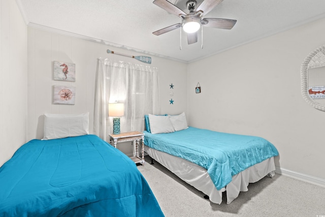 carpeted bedroom with ceiling fan and ornamental molding