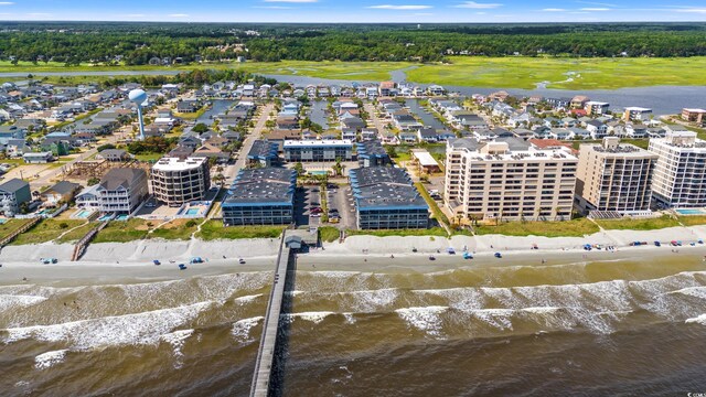 drone / aerial view with a water view and a beach view