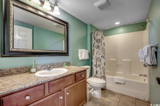 bathroom featuring visible vents, toilet, shower / bath combo, vanity, and tile patterned flooring