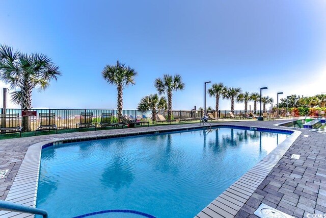 pool featuring a patio area and fence