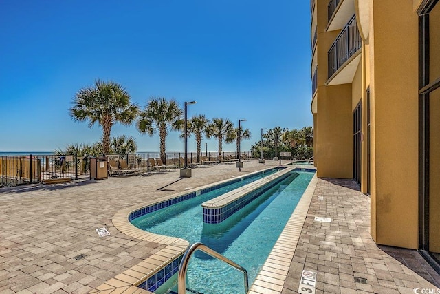 pool featuring a patio area and fence