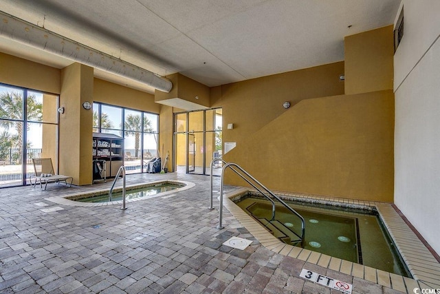 view of pool with a pool and an indoor hot tub