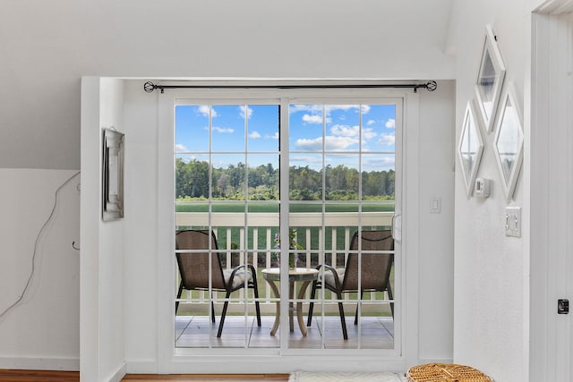 dining area with plenty of natural light and hardwood / wood-style floors