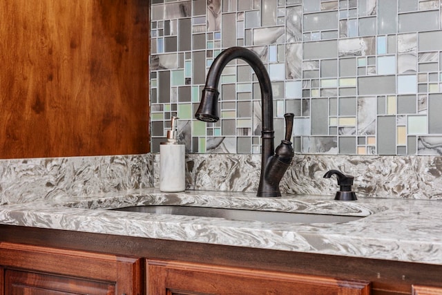 interior details featuring tasteful backsplash and sink