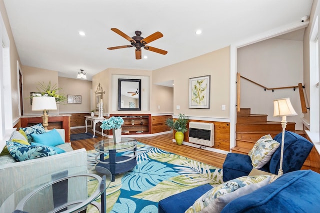 living room featuring ceiling fan, wood-type flooring, and heating unit