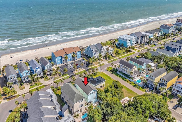 drone / aerial view featuring a beach view and a water view