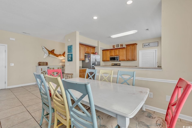 dining area with light tile patterned floors