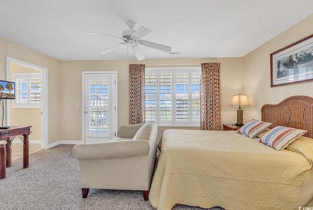 carpeted bedroom featuring multiple windows, ceiling fan, and access to exterior