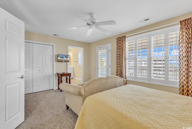 carpeted bedroom with ensuite bathroom, ceiling fan, and a closet