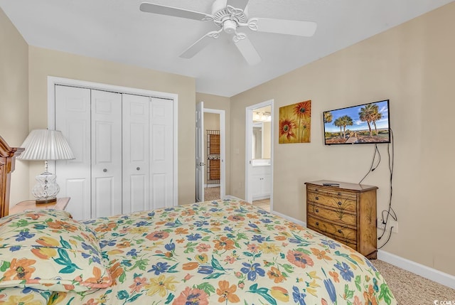 bedroom featuring a closet, ceiling fan, light colored carpet, and ensuite bathroom