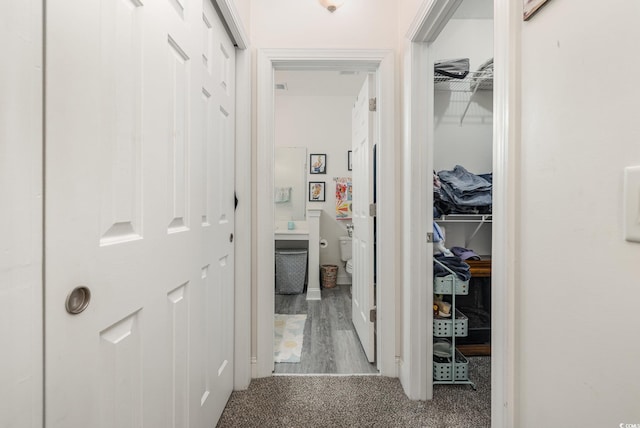 corridor with hardwood / wood-style floors