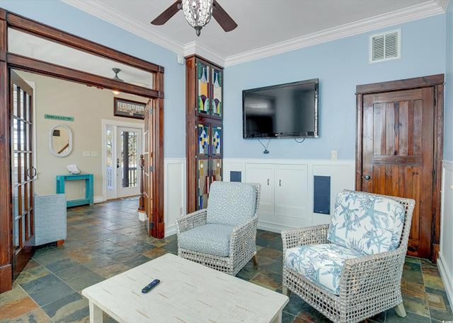 living room with french doors, ceiling fan, and ornamental molding