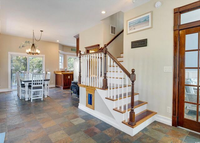 stairs with a chandelier