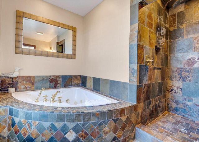 bathroom featuring plus walk in shower